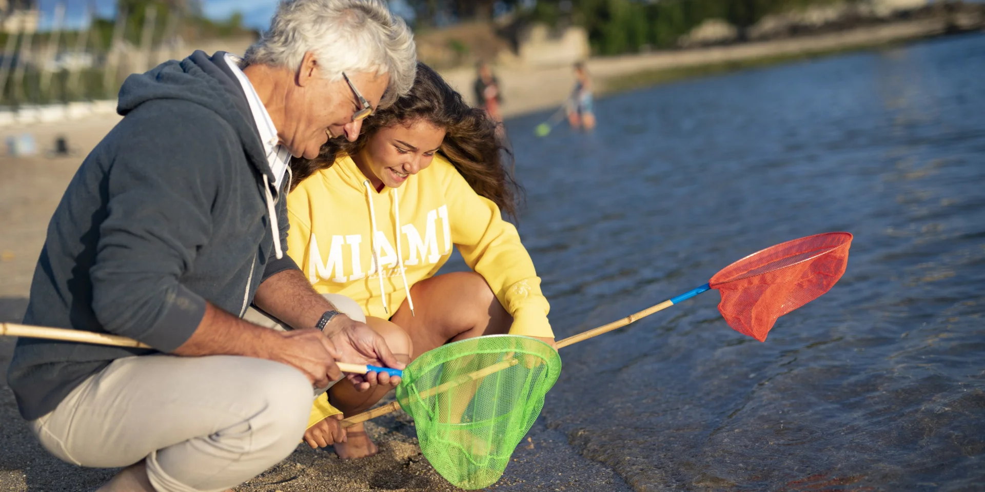 Family with landing nets for shore fishing