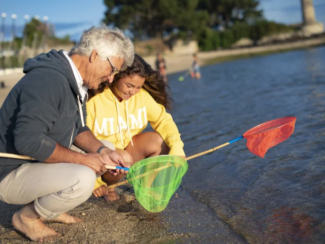 Family with landing nets for shore fishing