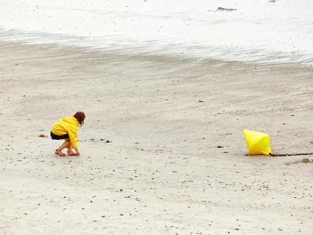 Child collecting shells on Cap-Coz beach in Fouesnant