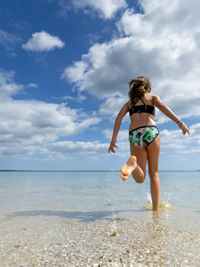 Young girl running for a swim